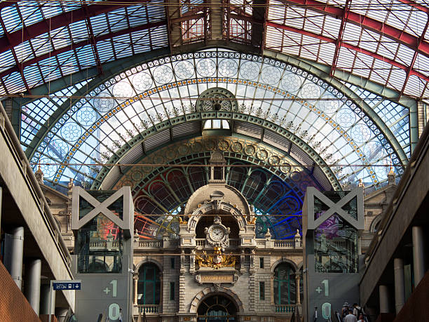 istock Antwerp Central Station Train Shed View - Dramatic view inside the Antwerp Central Train Station in Belgium, featuring the train shed and clock tower building. 2241550876