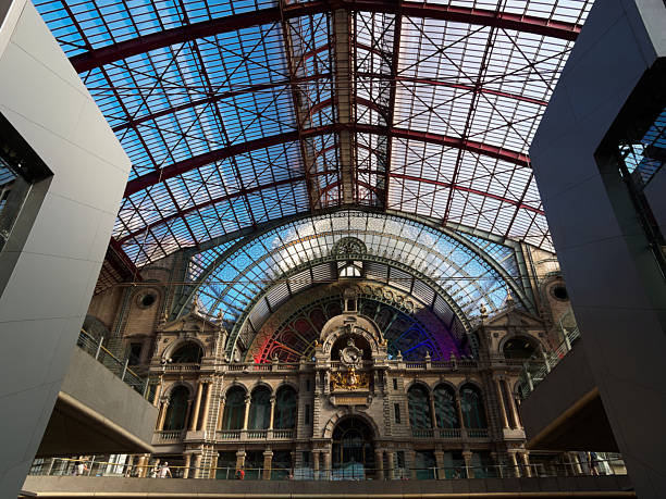 istock Antwerp Central Station Train Shed View - Dramatic view inside the Antwerp Central Train Station in Belgium, featuring the train shed and clock tower building. 2241550878