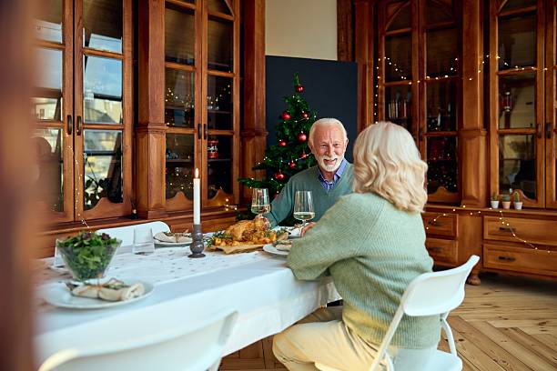 istock Joyful Couple Sharing New Year Dinner by Christmas Tree in Warm, Festive Home Setting 2241551290