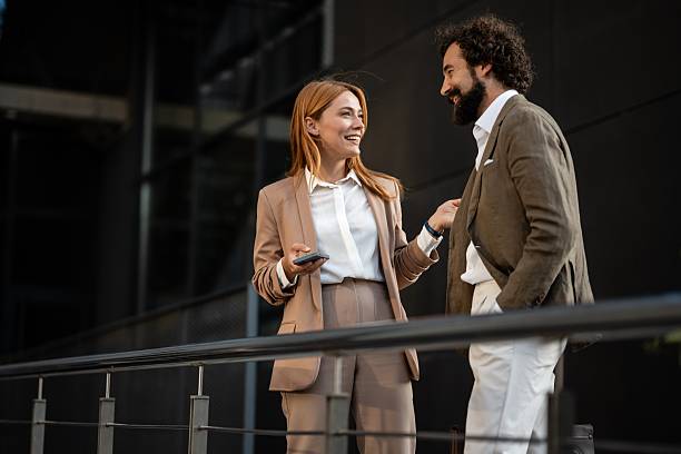 istock Businesspeople having a lively conversation outside office building 2241551515