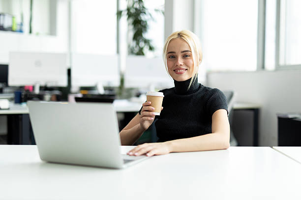 istock Professional businesswoman smiling and working in modern office 2241552889