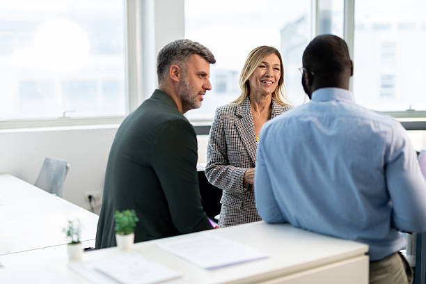 istock Business professionals having informal discussion in modern office 2241552894