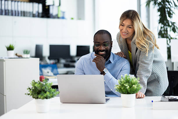 istock Diverse business colleagues collaborating on laptop in modern office 2241554456