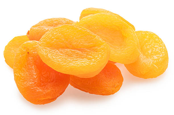 istock Dried pitted apricots isolated on white background. 2241555184