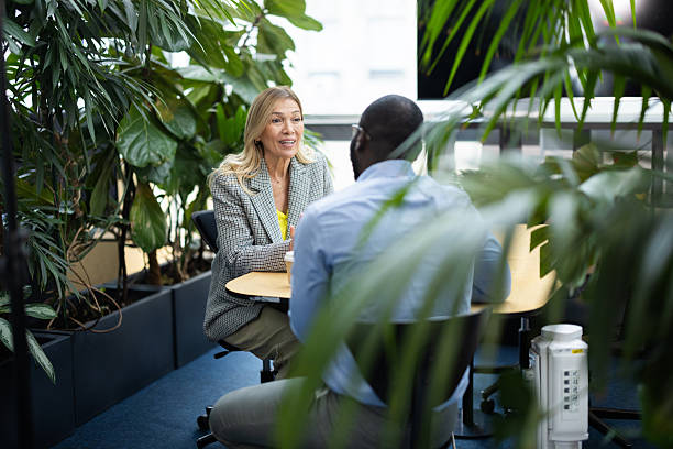 istock Business colleagues having conversation in modern green office 2241556418