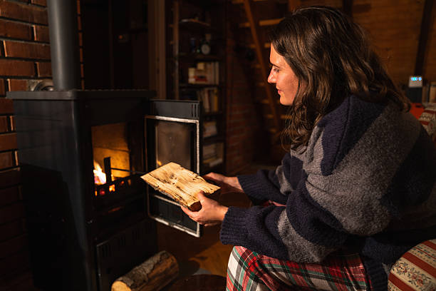 A woman uses the stove in the evening