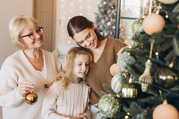 istock Three Generations Decorating Christmas Tree Together at Home 2241557294