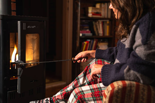 istock A woman uses the stove 2241557655