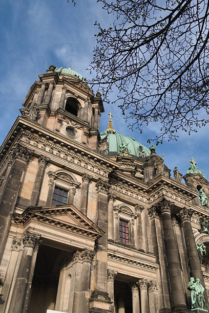 istock Berlin Cathedral Dome and Tower Low Angle - Dramatic low-angle view of the majestic Berliner Dom (Berlin Cathedral), showcasing its grand Baroque Revival dome and stone facade under a blue sky. 2241558713