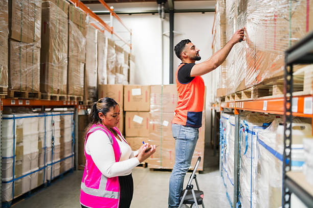 Logistics team conducting inventory audit inside warehouse.