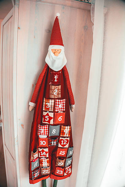 The image features a red advent calendar door with the number 15, symbolizing anticipation and the Christmas season. The close-up view enhances the festive atmosphere and sense of excitement.