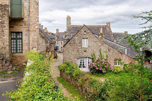 istock Charming stone house with hydrangea garden along cobblestone path in the quaint historic village of Locronan in Brittany, France. 2241561667