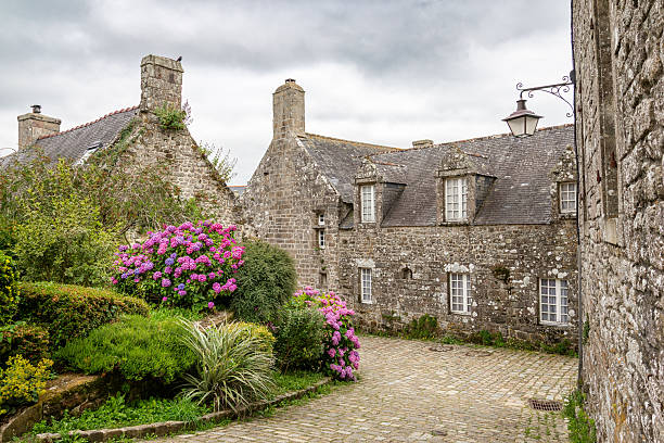 istock Charming stone house with hydrangea garden along cobblestone path in the quaint historic village of Locronan in Brittany, France. 2241561683