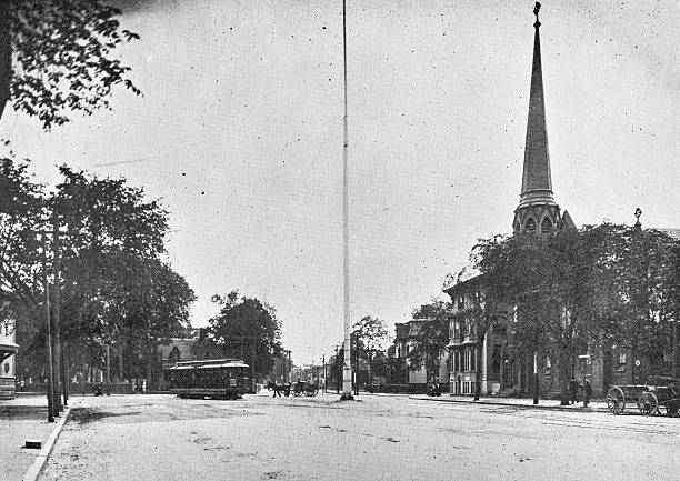istock Providence, Rhode Island, Trinity Square, Broad Street looking north, where the first asphalt pavement replaced the old cobblestones — a quiet scene marking the city’s passage from horse-drawn days to the modern age 2241561762