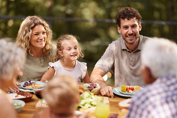 istock Happy extended family talking during lunch on a terrace. 2241562676