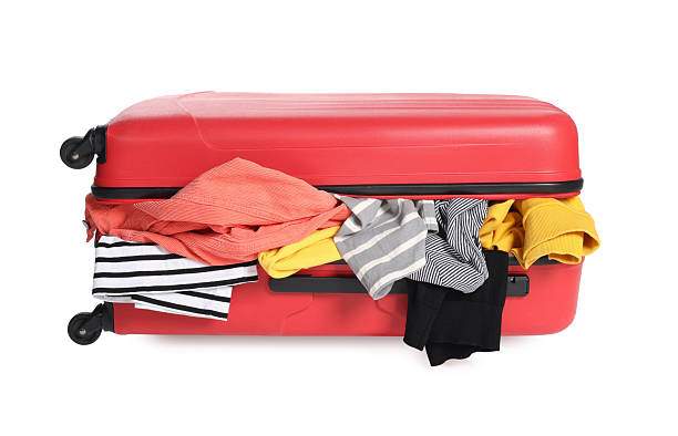 istock Packed suitcase full of clothes isolated on white 2241562721