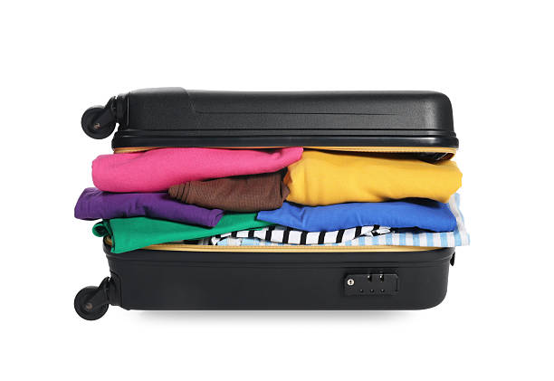 istock Packed suitcase full of clothes isolated on white 2241562865