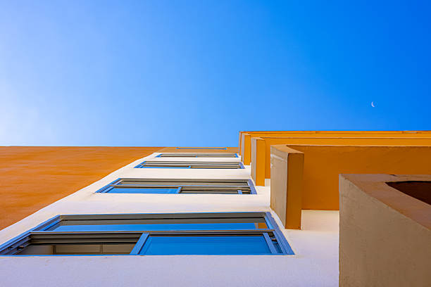 istock Modern yellow and white building with blue sky minimal architecture perspective 2241565169