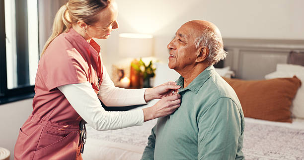 istock Nurse, help and clothes with old man in bedroom for dressing, advice and support. Getting ready, morning routine and healthcare with caregiver and patient in nursing home for retirement and trust 2241565747
