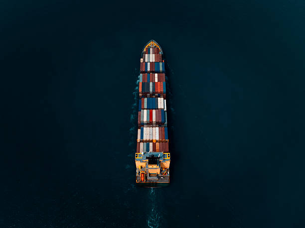 istock photograph of large container ship sailing on a deep sea, fully loaded with multi-colored containers, reflecting global maritime transport and logistics, cinematic dark tone  process. 2241566956