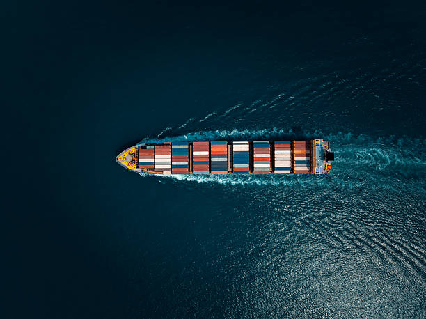 istock photograph of large container ship sailing on a deep sea, fully loaded with multi-colored containers, reflecting global maritime transport and logistics, cinematic dark tone  process. 2241566962