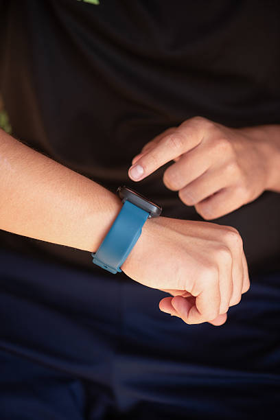 istock Person interacting with smartwatch on wrist while sitting outdoors 2241567218