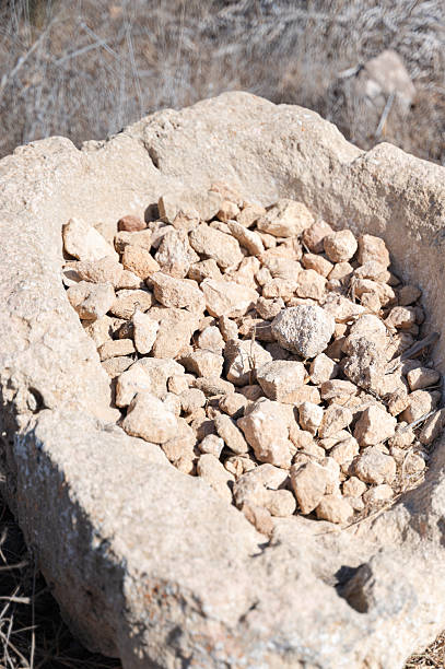An Ancient Stone Basin Filled with Crushed Rocks is Set in a Vast Arid Landscape