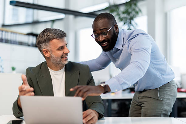 istock Diverse business colleagues collaborating on laptop in office 2241568493