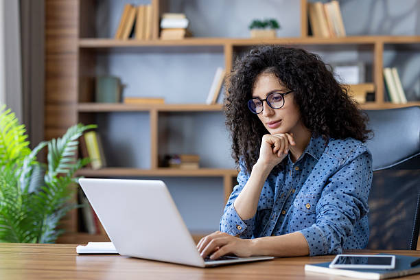 istock Young woman working on laptop in home office 2241572248
