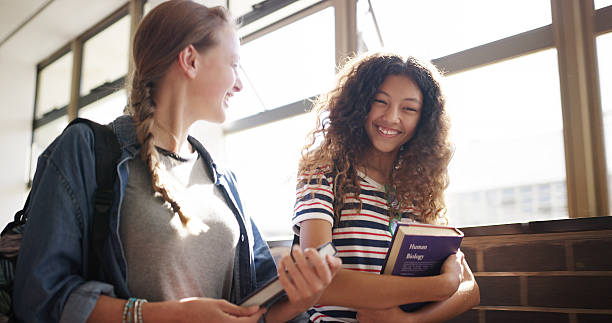 istock Smile, students and walking with friends in high school for education, project assignment and study team. Happy, learning and exam planning with teenager or girl in hallway for conversation and chat 2241574568