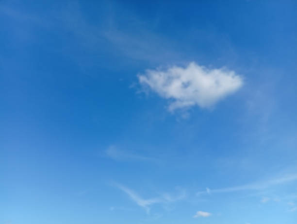 istock Single fluffy cloud floats in clear blue sky, creating serene and peaceful atmosphere 2241574666