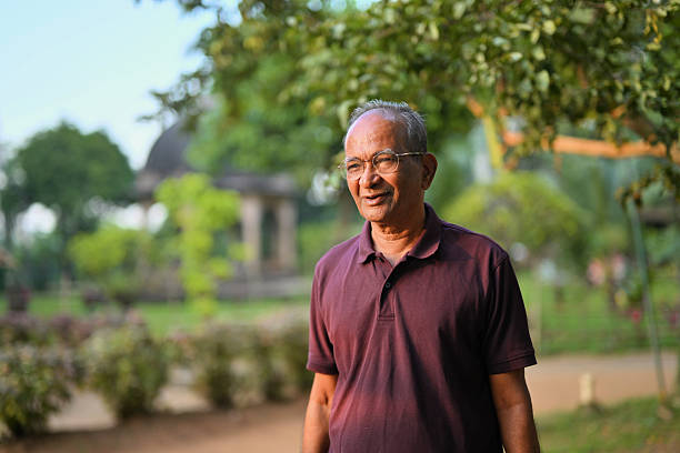 istock Senior man enjoying an evening Walk in the Park 2241575585