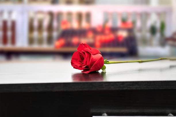 istock Red Rose over coffin at the church 2241575764