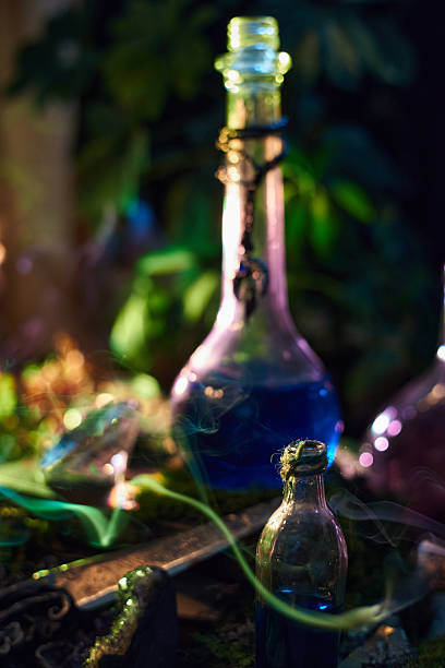 istock Brightly colored potion bottles are gathered on a surface surrounded by lush greenery. scene is infused with a magical aura as twilight casts enchanting shadows 2241577907