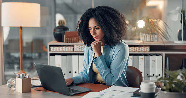 istock Woman, laptop and review at startup with stats, solution or confused with info at digital agency. Person, computer and documents with decision, graphs or report for social media marketing at company 2241578507