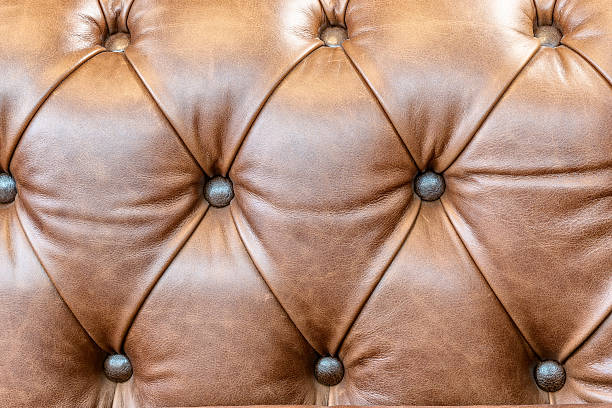 istock brown leather sofa armrest with carriage tie and brass rivets 2241579174