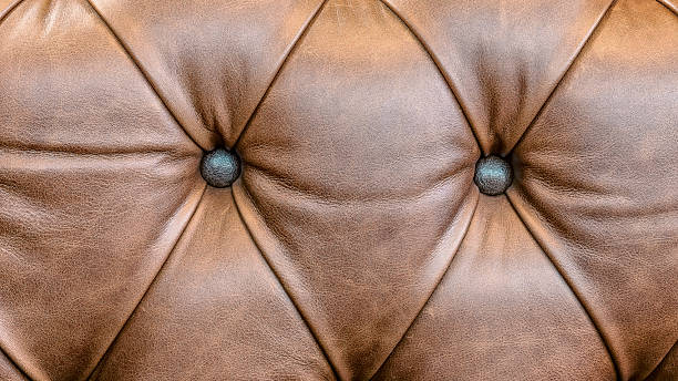 istock brown leather sofa armrest with carriage tie and brass rivets 2241579180
