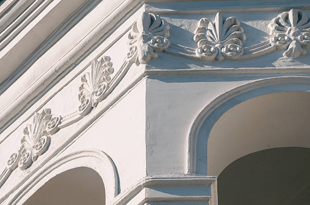 Stunning architectural detail highlights the elegance of a renovated building's facade against blue sky