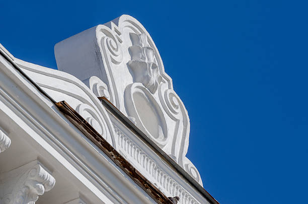 Stunning architectural detail highlights the elegance of a renovated building's facade against blue sky