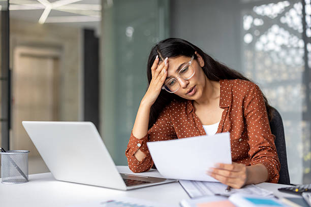 istock Woman feeling stressed about financial debt and paperwork 2241581064