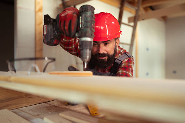man with a screwdriver in his hands on a white background, a foreman in uniform.