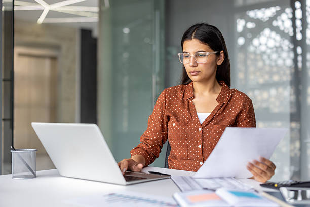 istock Indian businesswoman working with laptop and documents in office 2241581721