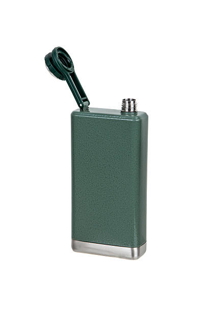 istock Green hip flask with attached screw cap open, showing the metal neck. 2241581943