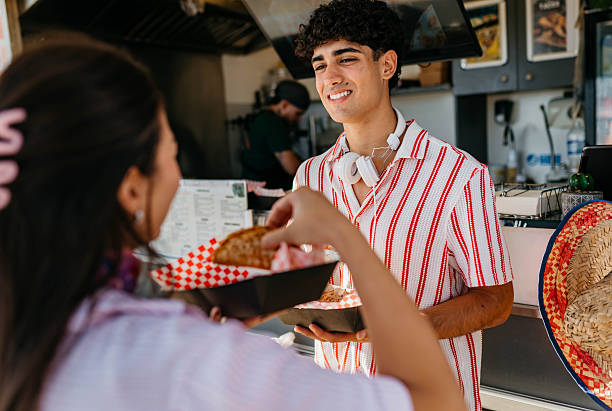 istock Happy pair enjoying street tacos 2241584029