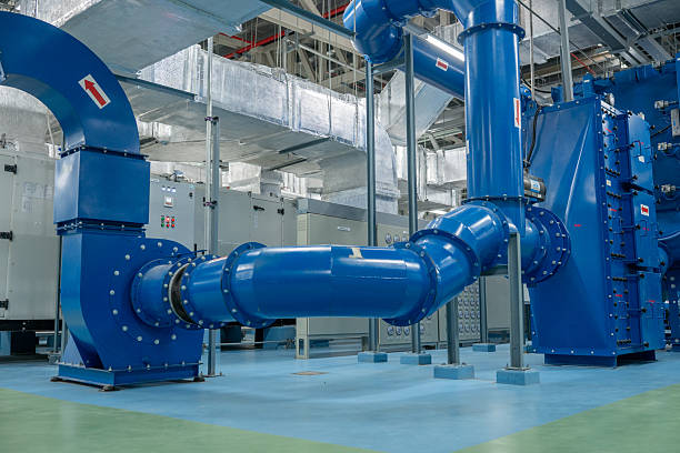 istock Modern industrial facility featuring large blue mechanical pipes and advanced ventilation systems  interior high-tech plant or factory, highlighting metal ducts, air filtration systems complex engineering infrastructure 2241584043