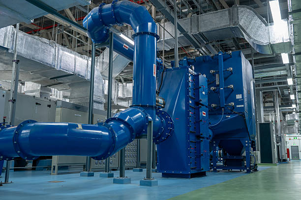 istock Modern industrial facility featuring large blue mechanical pipes and advanced ventilation systems  interior high-tech plant or factory, highlighting metal ducts, air filtration systems complex engineering infrastructure 2241584050