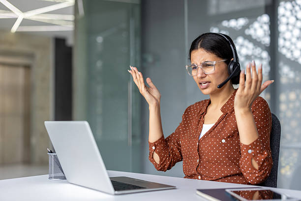 istock Stressed customer service representative arguing during video call on laptop 2241584133