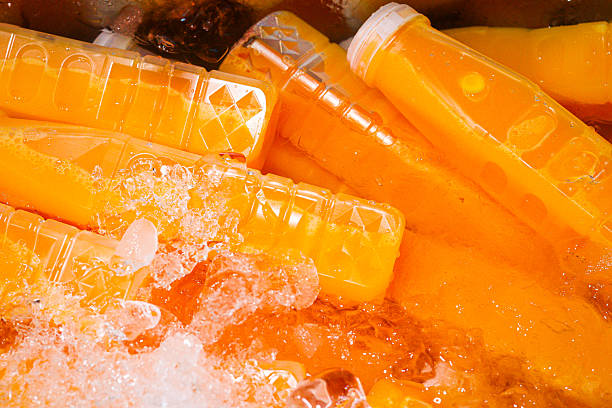 istock Orange juice bottles on ice 2241584413
