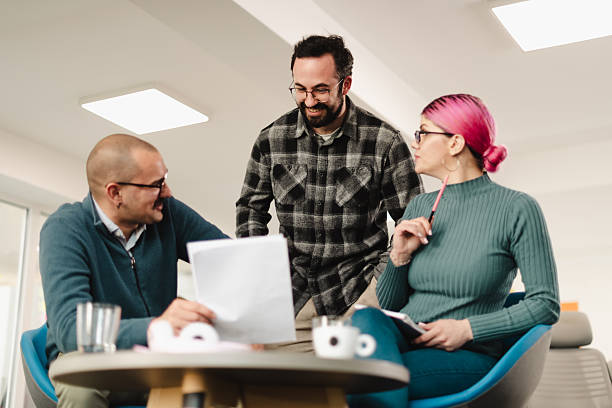 istock Business meeting with professionals collaborating in a modern office setting during the afternoon to discuss strategies and ideas for future projects 2241591041
