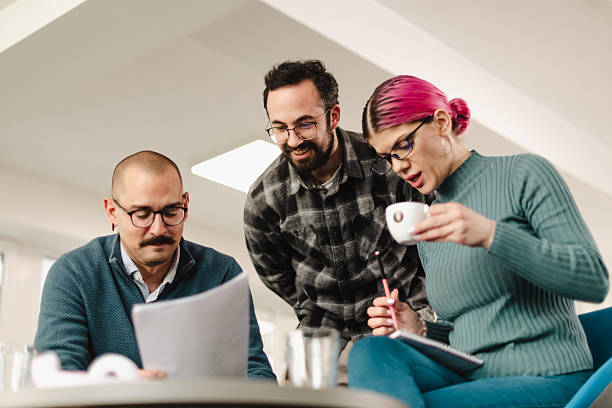 istock Business meeting with professionals discussing ideas in modern office space during daytime 2241591047
